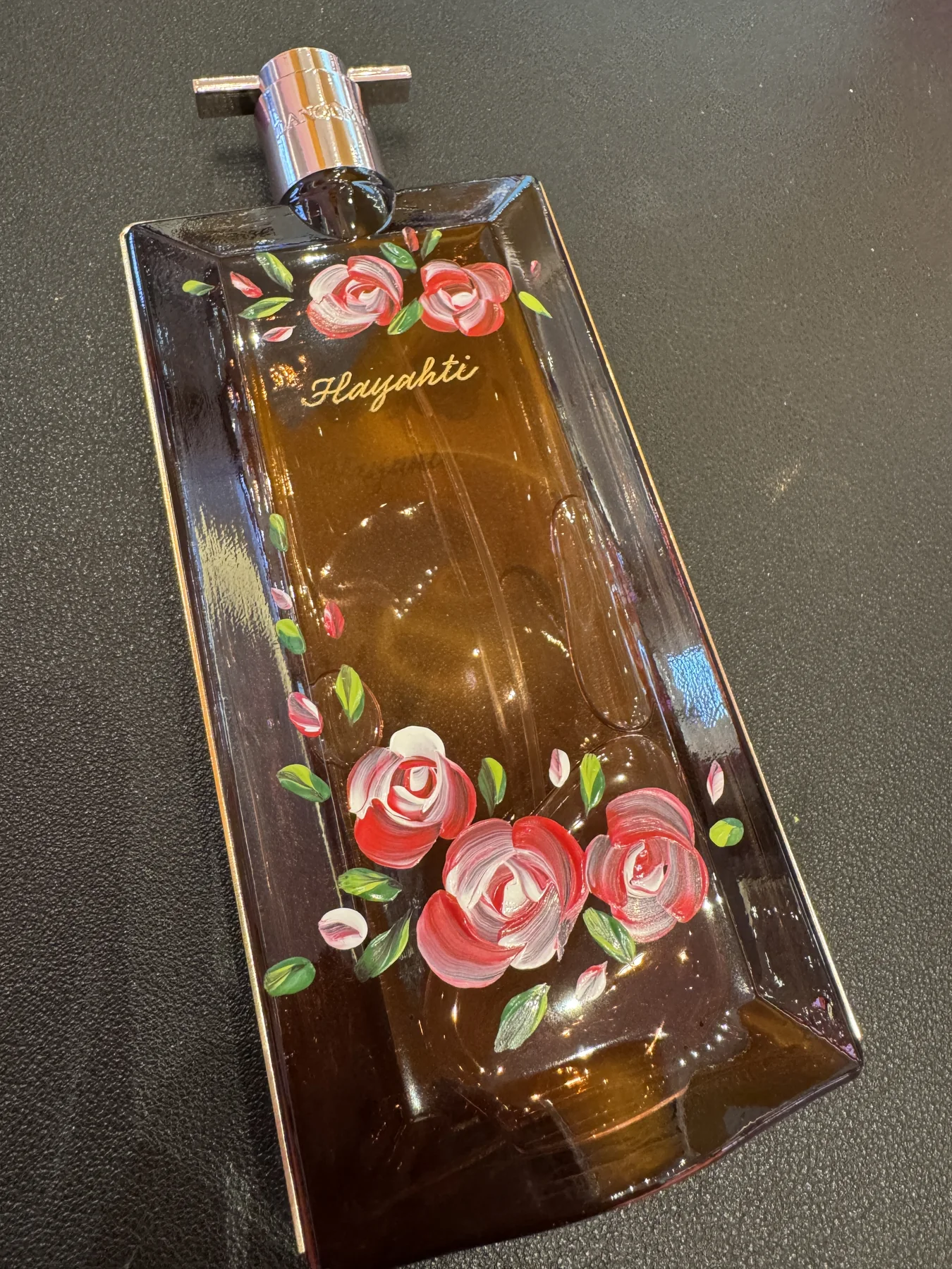 Rose artwork painted on a bottle